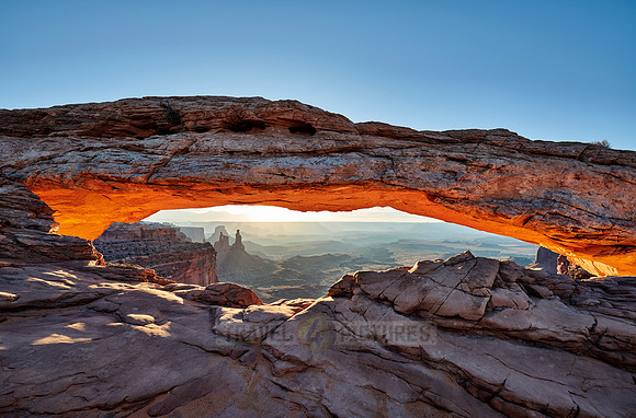 sun rises at Mesa Arch in Canyonlands National Park