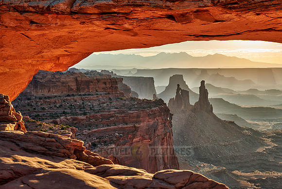 sun rises at Mesa Arch in Canyonlands National Park