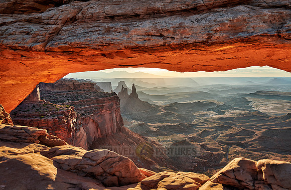 sun rises at Mesa Arch in Canyonlands National Park