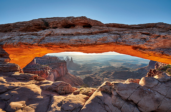 sun rises at Mesa Arch in Canyonlands National Park