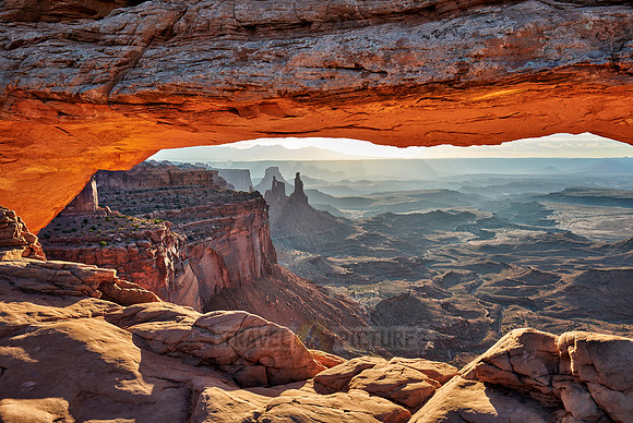 sun rises at Mesa Arch in Canyonlands National Park