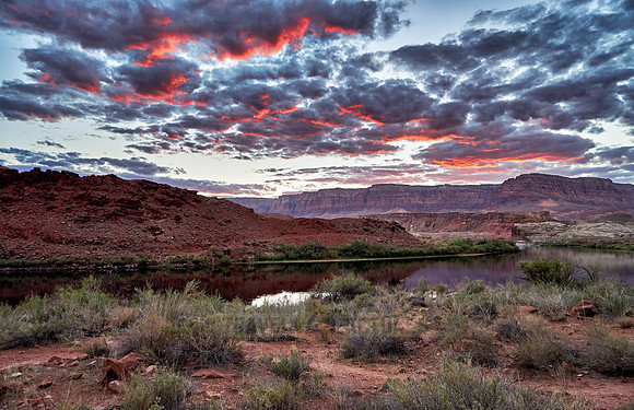 sunset is glowing in clouds over Colorado river and Vermillion Cliffs