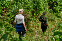 Tourist and Ranger walking through forest down to Lake Empakaai