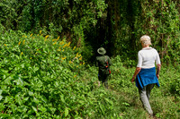 Tourist and Ranger walking through forest down to Lake Empakaai