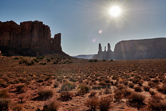 Three Sisters and sun in Monument Valley
