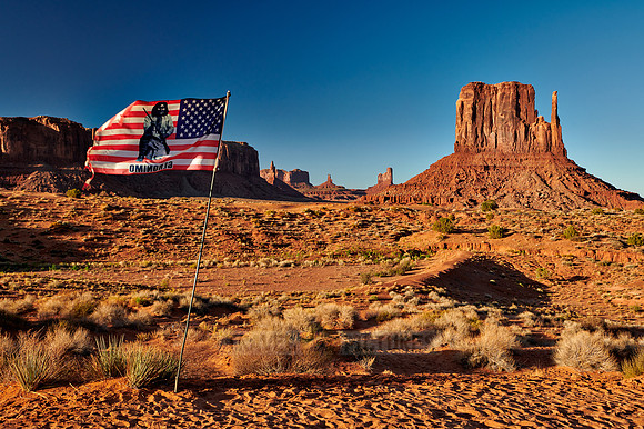 American flag with The West Mitten Butte in Monument Valley