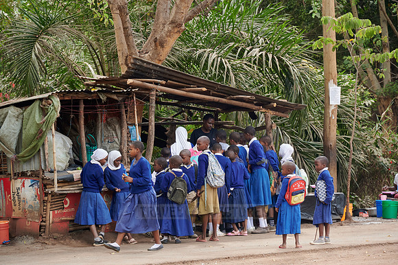 school children in uniform at a sales booth