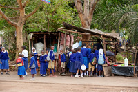 school children in uniform at a sales booth