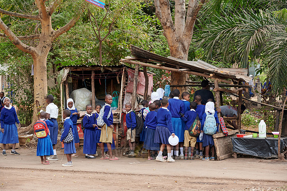 school children in uniform at a sales booth