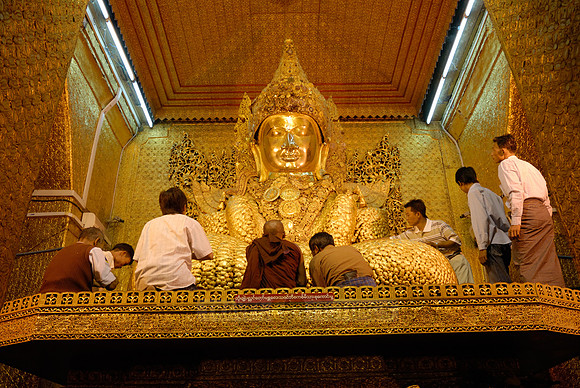 uddha with thick layer of golden leaves in Mahamuni Pagoda