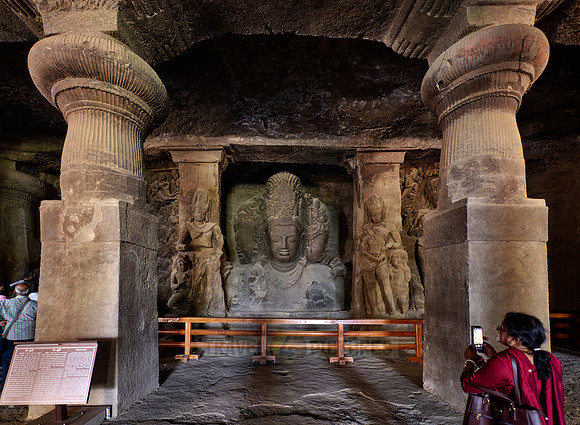 tourist in front of the Eternal Shiva, the Sadashiva, Elephanta caves