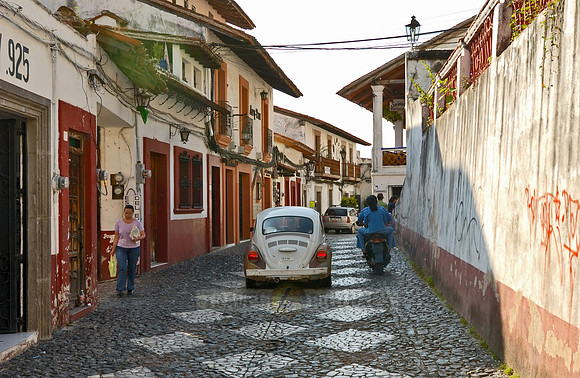 City view with typical buildings, in front VW Beetle