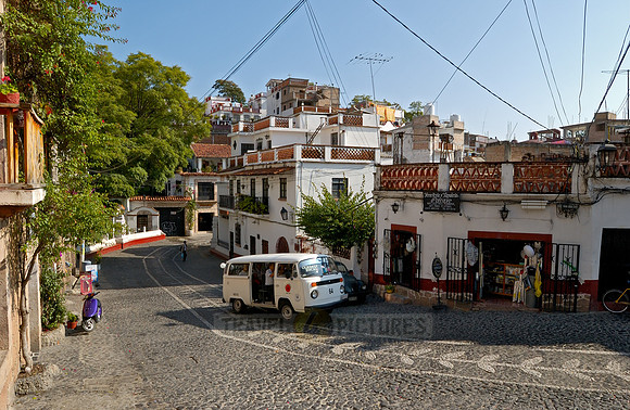 Street with typical houses of the colonial city, VW bus as a taxi in the foreground