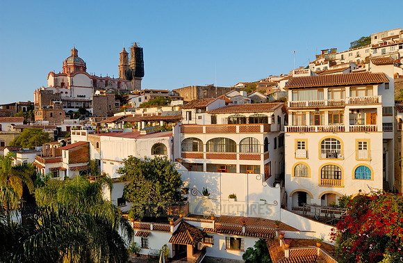 City view with San Sebastian y Santa Prisca Church and typical buildings