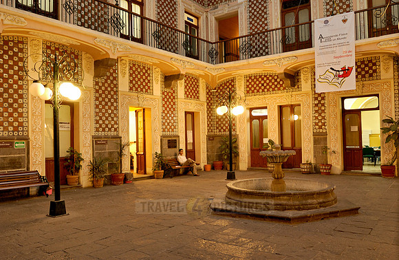 Inner courtyard with fountain and typical tile facades
