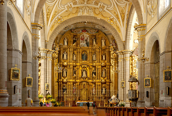 High altar richly decorated with gold, stucco and figures