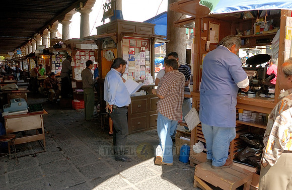 stalls with print products on Plaza Santo Domingo
