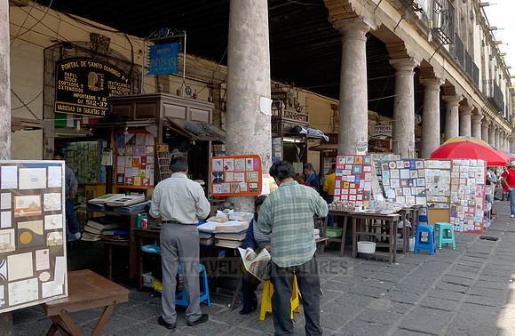 stalls with print products on Plaza Santo Domingo