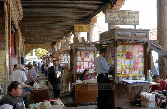 stalls with print products on Plaza Santo Domingo