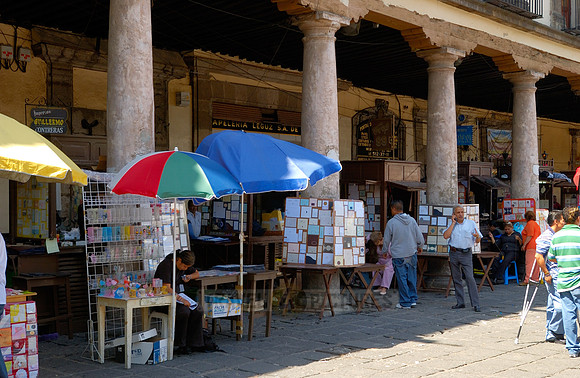 stalls with print products on Plaza Santo Domingo