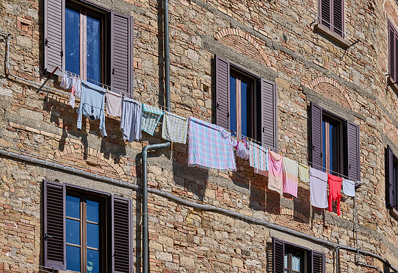 Laundry hangs to dry on Volterra windows