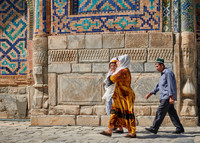 locals with traditional clothes in inner courtyard of Tilya-Kori-Madrasah