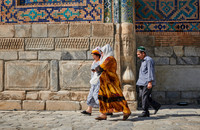 locals with traditional clothes in inner courtyard of Tilya-Kori-Madrasah
