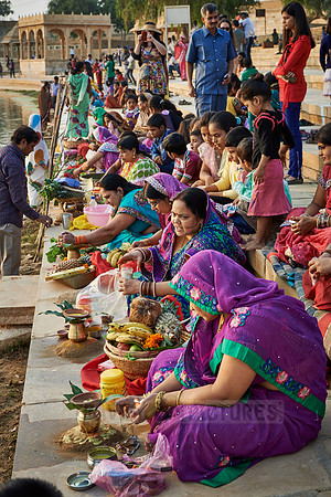 colorful dressed women celebrating ceremony at Ghat