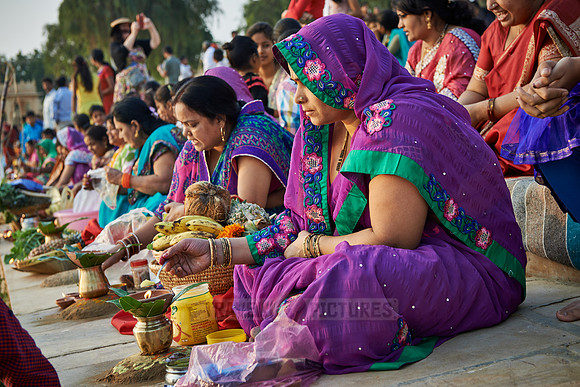 colorful dressed women celebrating ceremony at Ghat