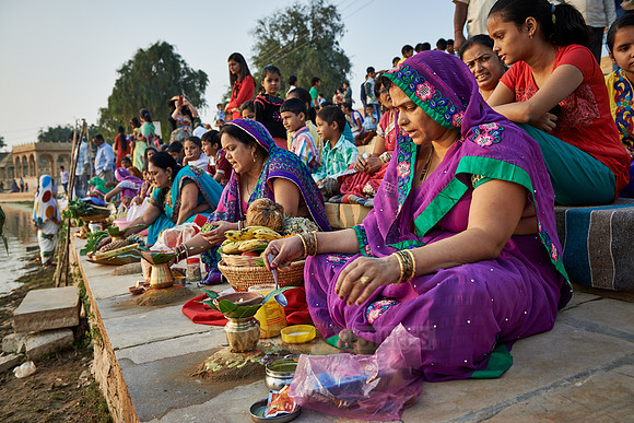 colorful dressed women celebrating ceremony at Ghat