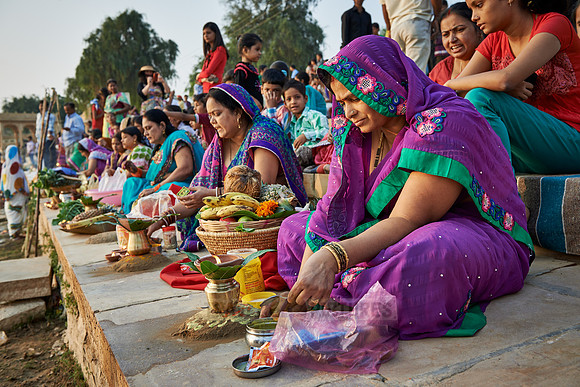 colorful dressed women celebrating ceremony at Ghat