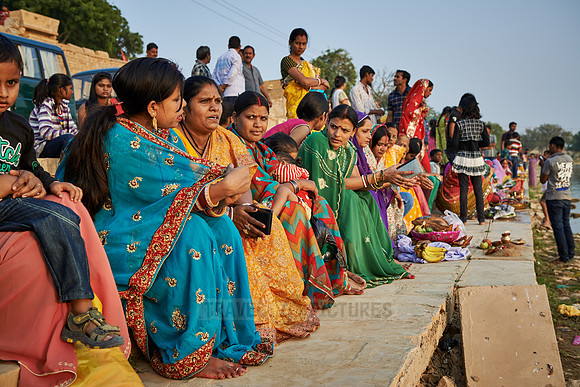 colorful dressed women celebrating ceremony at Ghat