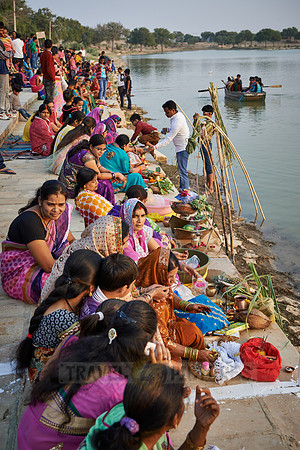 colorful dressed women celebrating ceremony at Ghat