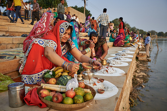 colorful dressed women celebrating ceremony at Ghat