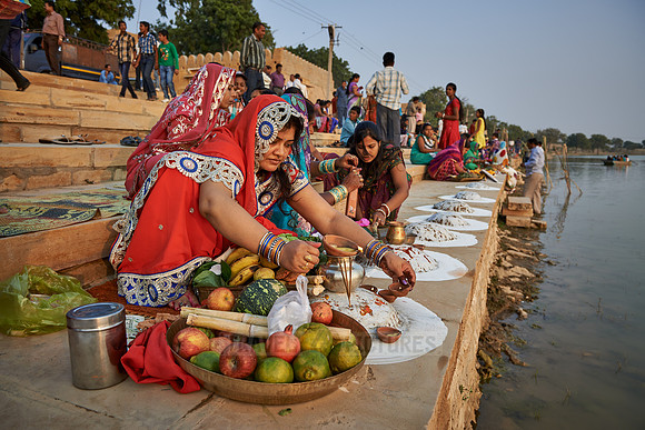 colorful dressed women celebrating ceremony at Ghat