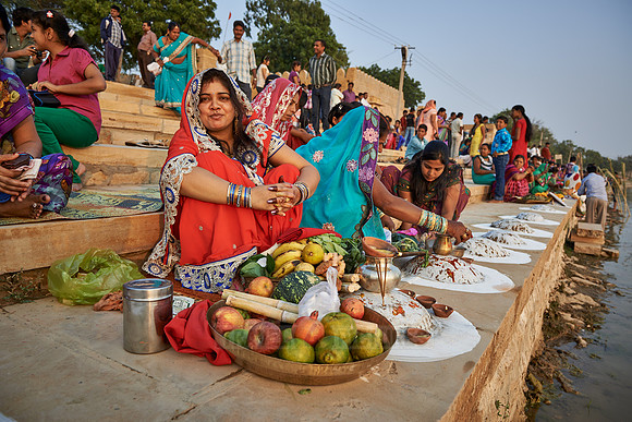 colorful dressed women celebrating ceremony at Ghat