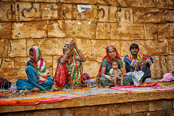 colorful and traditionally dressed people selling souvenirs