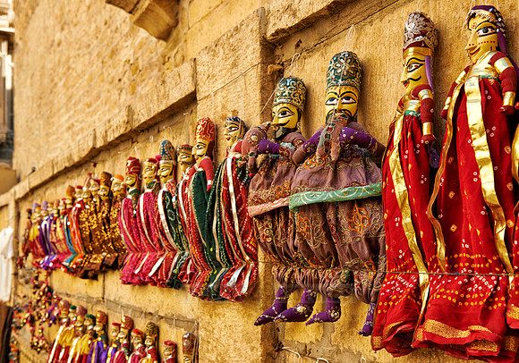 puppets hanging on a wall in Jaisalmer