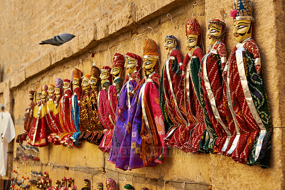 puppets hanging on a wall in Jaisalmer