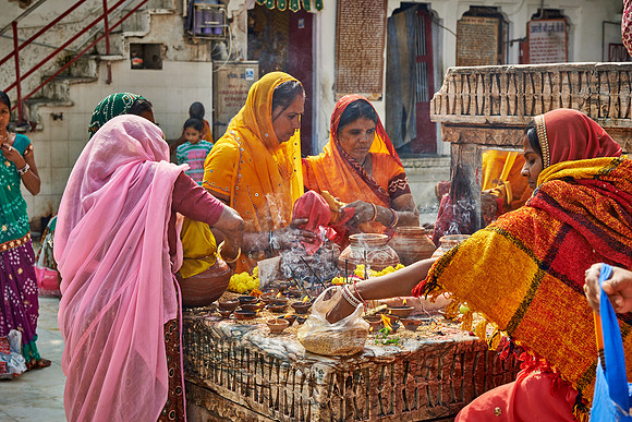 indian women with colorful clothes during ceremony inside Jagdish Temple
