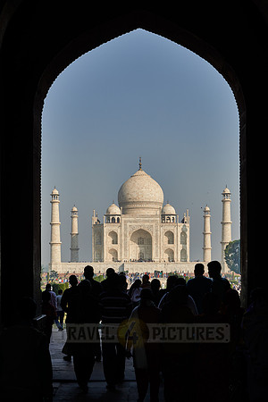 Tourists walking thru The Great Gate to Taj Mahal