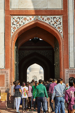 Tourists walking thru The Great Gate to Taj Mahal