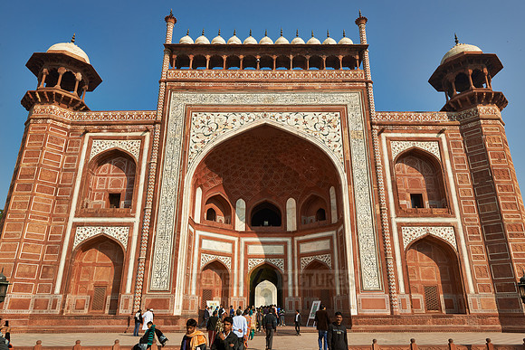 Tourists walking thru The Great Gate to Taj Mahal