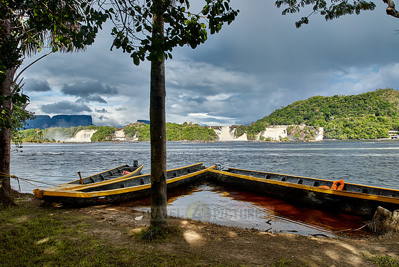 boats in front of waterfalls in lagoon of Canaima
