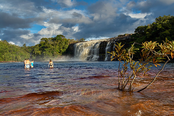 tourists swimming in front of El Sapo Waterfalls