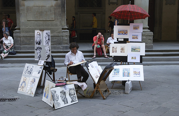 Street artist, painter with tourist at the Uffizi Galleries