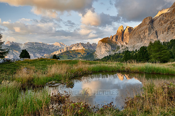Sella group is reflected in a small lake