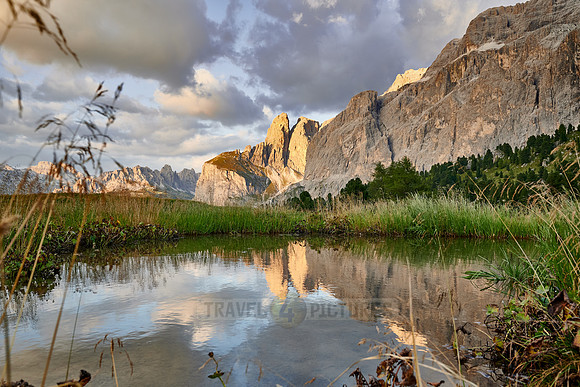 Sella group is reflected in a small lake