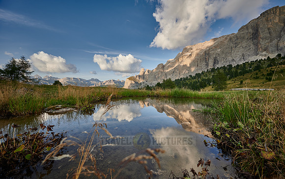 Sella group is reflected in a small lake