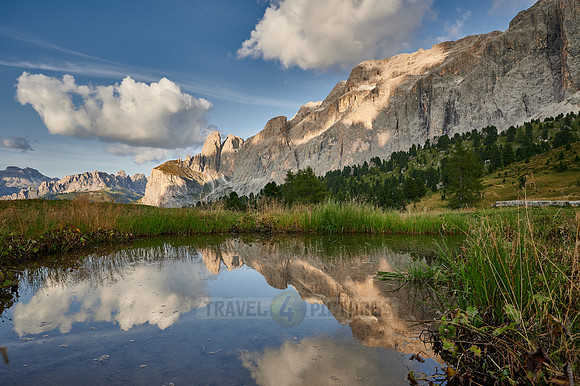 Sella group is reflected in a small lake